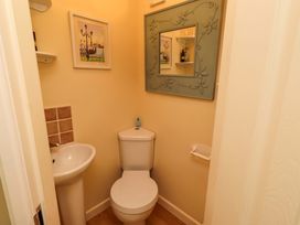 A bathroom with a toilet and hand basin at Rose Briar Cottage Morpeth