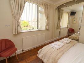 A bedroom with a bed and towels at Rose Briar Cottage in Morpeth