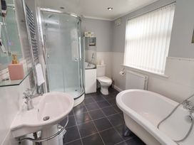 A bathroom with a shower, bathtub, toilet, and sink at Rose Briar Cottage in Morpeth