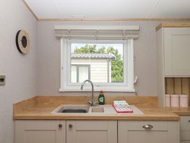 A kitchen with a sink and tap at Maple Lodge Teigngrace near Kingsteignton