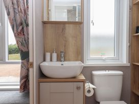 A bathroom with a sink and toilet at Maple Lodge Teigngrace near Kingsteignton