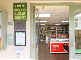 A store entrance with signs and shelves at Maple Lodge in Teigngrace near Kingsteignton