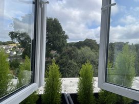 View from a window with plants on a ledge at Queensbury Loft in Par