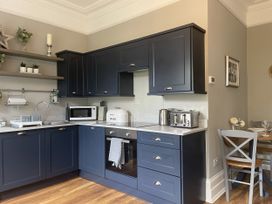 A kitchen with cabinets and appliances at DeCressy Apartment in Par