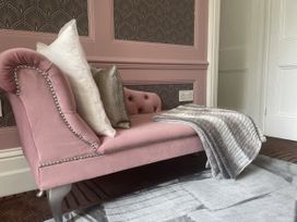 A sofa with cushions and a blanket in DeCressy Apartment in Par