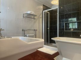 A bathroom with a shower and bathtub at DeCressy Apartment in Par