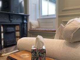 A living room with a television and fireplace at Garden Apartment in Par