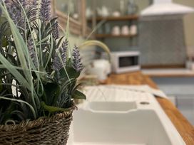 A kitchen with a sink and plant at Garden Apartment in Par