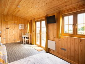 A glamping hut interior with wooden features at Head For the Hills Glamping - Skylark Shepherd's Hut