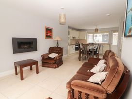 A living room with a sofa and armchair at 1 Windermere in Kinvarra