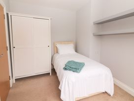 A bedroom with a bed and wardrobe at 1 Windermere in Kinvarra