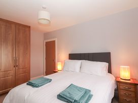 A bedroom with a bed and towels on it at 1 Windermere in Kinvarra