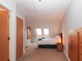 A bedroom with a bed and windows at 1 Windermere in Kinvarra