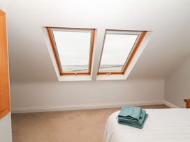A bedroom with roof windows and towels on the bed at 1 Windermere in Kinvarra