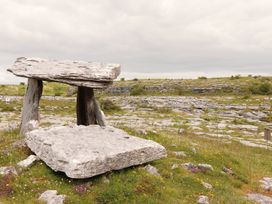 A stone table surrounded by grass and rocks at 1 Windermere in Kinvarra