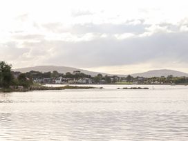 A view of water with buildings and hills in the background at 1 Windermere in Kinvarra