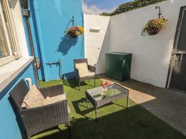 An outdoor seating area with a glass table and storage box at 1 Windermere, Kinvara, County Galway