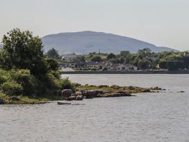A view of a mountain overlooking water and houses near the shore at 1 Windermere, Kinvara, County Galway
