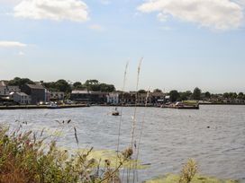 A view of a river with houses and boats at 1 Windermere in Kinvara, County Galway
