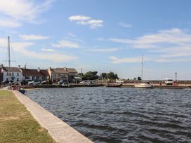 A view of boats near buildings along the water at 1 Windermere in Kinvara, County Galway