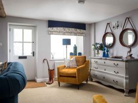 A living room featuring a yellow chair and a window at Lavender Cottage (Stow-on-the-Wold) Cheltenham