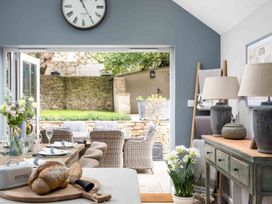 A kitchen with dining area and patio access at Lavender Cottage (Stow-on-the-Wold) Cheltenham