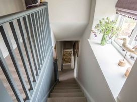 A staircase with a handrail and a window at Lavender Cottage (Stow-on-the-Wold) Cheltenham