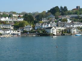 A view of houses and boats by the water at The Porthole in Newton Ferrers