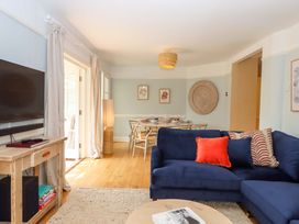 A living room with a sofa and television at The Porthole in Newton Ferrers