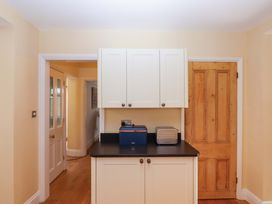 A kitchen with cupboards and appliances at The Porthole in Newton Ferrers