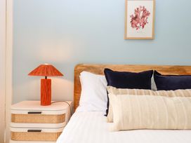 A bedroom with a bed and bedside table at The Porthole in Newton Ferrers