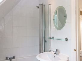 A bathroom with a shower and sink at The Porthole in Newton Ferrers