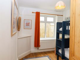 A bedroom with a bunk bed and window at The Porthole in Newton Ferrers