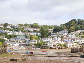 A seaside view with houses and boats at The Porthole in Newton Ferrers