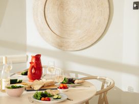 A dining room table set with food and drinks at The Porthole in Newton Ferrers