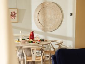 A dining room with a table set for a meal at The Porthole in Newton Ferrers