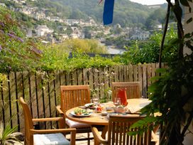 An outdoor dining area with a table and chairs at The Porthole Newton Ferrers