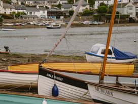 A view of boats on water with houses in the background at The Porthole in Newton Ferrers