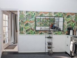 A kitchen with a mirror and cookware at 26 Above Town in Dartmouth