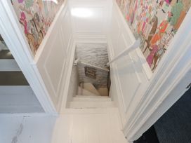 A staircase leading down with a sign at 26 Above Town Dartmouth