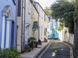 A street with colorful houses and a plant pot at 26 Above Town in Dartmouth