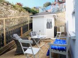 An outdoor terrace with seating and a shed at 26 Above Town in Dartmouth