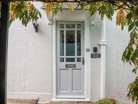 An entrance with a white door and a parking permit sign at 26 Above Town in Dartmouth