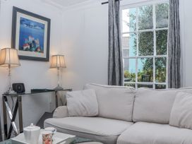 A living room with a sofa and a table at 26 Above Town in Dartmouth