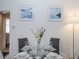 A dining room with a glass table and chairs at 26 Above Town Dartmouth