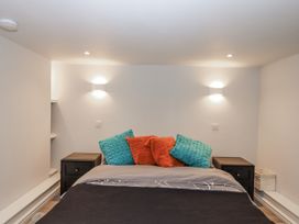 A bedroom with a bed and nightstands at 26 Above Town in Dartmouth