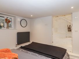 A bedroom featuring a bed and staircase at 26 Above Town Dartmouth