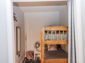 A bedroom with a bunk bed and a fan at 26 Above Town Dartmouth