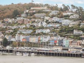 A view of colorful houses on a hill by the marina at 26 Above Town in Dartmouth