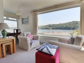 A living room with a view of the water at Kiln Cottage in Golant near Tywardreath